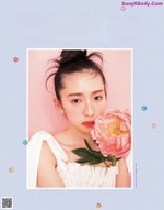 Miku Kanemura 金村美玖, BIS Magazine 2021.07 A woman holding a pink flower in front of her face.