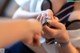 A woman getting her nails done at a wedding.